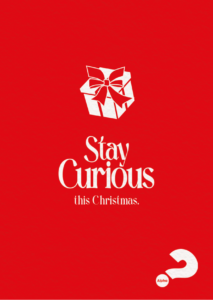 red background, white text saying stay curious this christmas with a graphic of a white gift box and a question mark