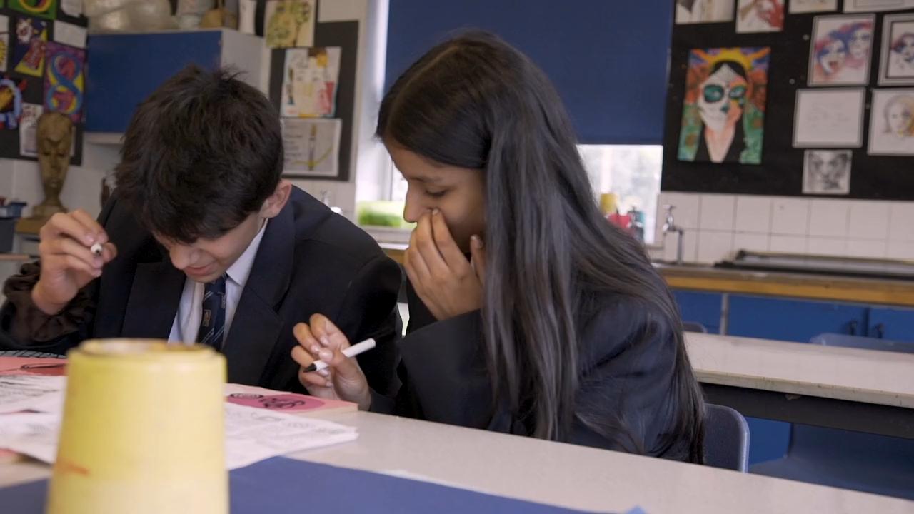 Students working in art lesson.